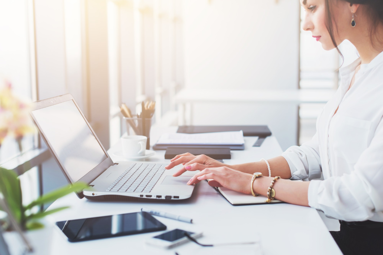 attractive-female-assistant-working-typing-using-portable-computer-concentrated-looking-at-the-monitor-office-worker-reading-business-e-mail