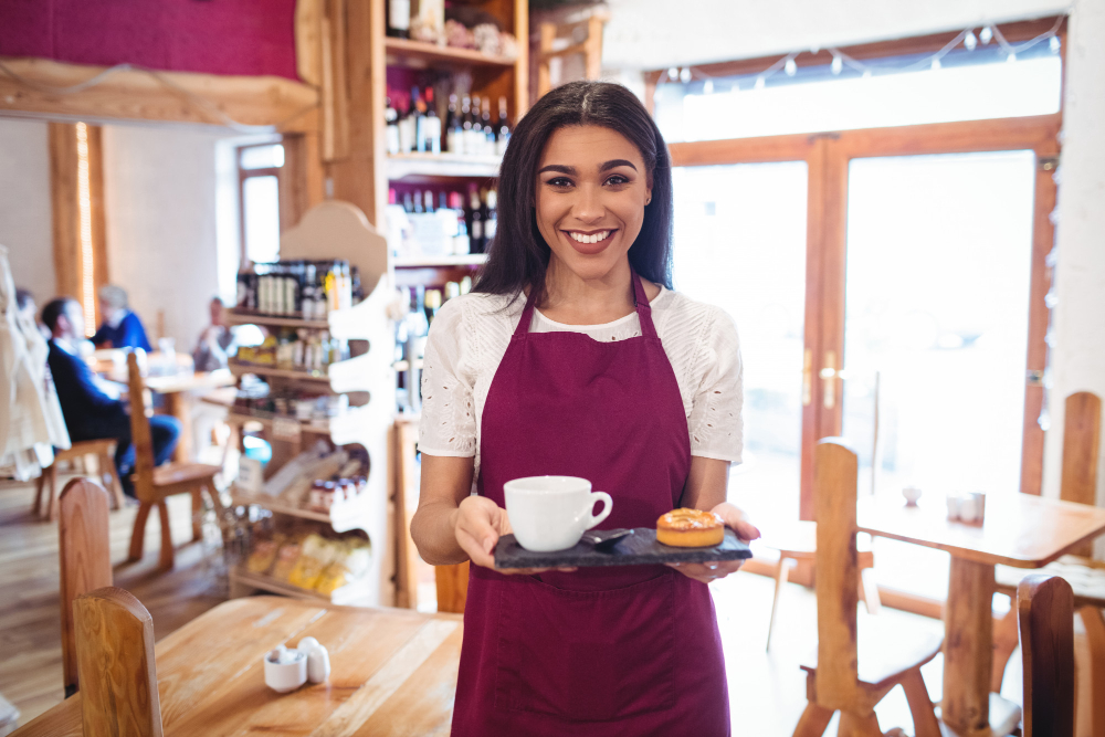 portrait-of-waitress-holding-cup-of-coffee-and-snacks