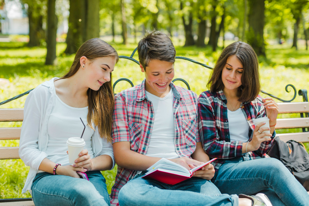 group-of-students-reading-book-together