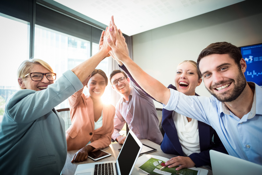 business-people-giving-high-five-at-desk