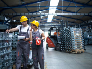 factory-workers-checking-quality-of-products-in-industrial-warehouse