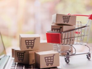 shopping-online-concept-parcel-or-paper-cartons-with-shopping-cart-logo-in-trolley-on-laptop-keyboard-shopping-service-on-the-online-web-offers-home-delivery (1)