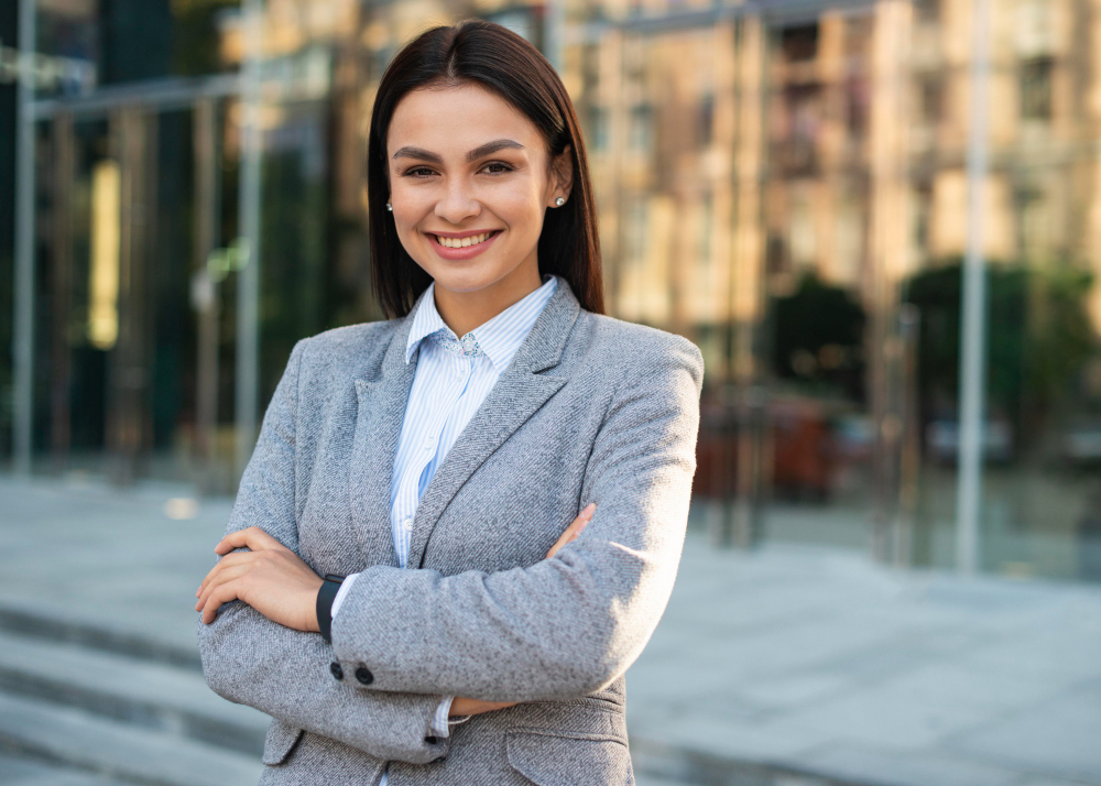smiley-businesswoman-posing-outdoors-with-arms-crossed-and-copy-space