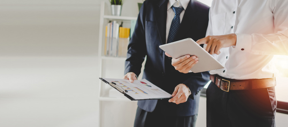 job-training-new-manager-boss-standing-teaching-online-work-with-mobile-tablet-young-intern-apprentice-learning-statistics-chart-working-office