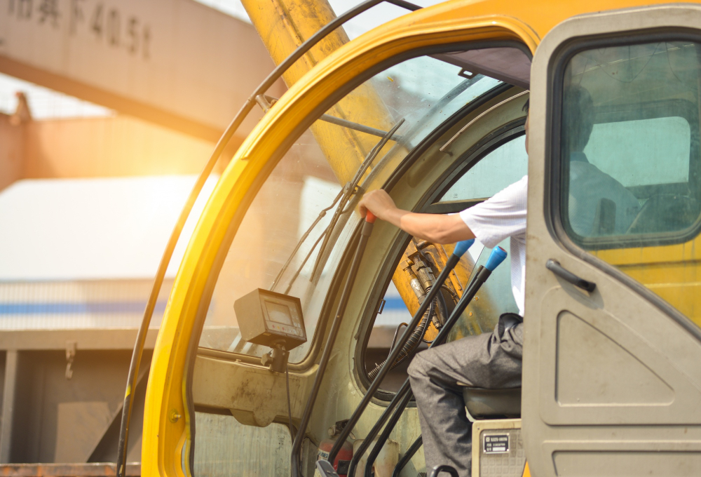 man-driving-crane-lift-up-some-equipments