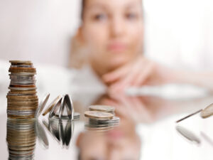 woman-look-on-pile-of-coins-column-of-coins-falls-business-crisis-concept-shallow-focus-high-quality-photo