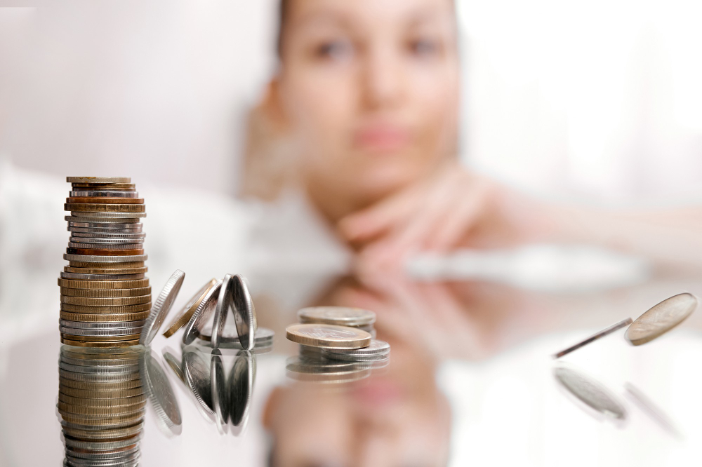 woman-look-on-pile-of-coins-column-of-coins-falls-business-crisis-concept-shallow-focus-high-quality-photo
