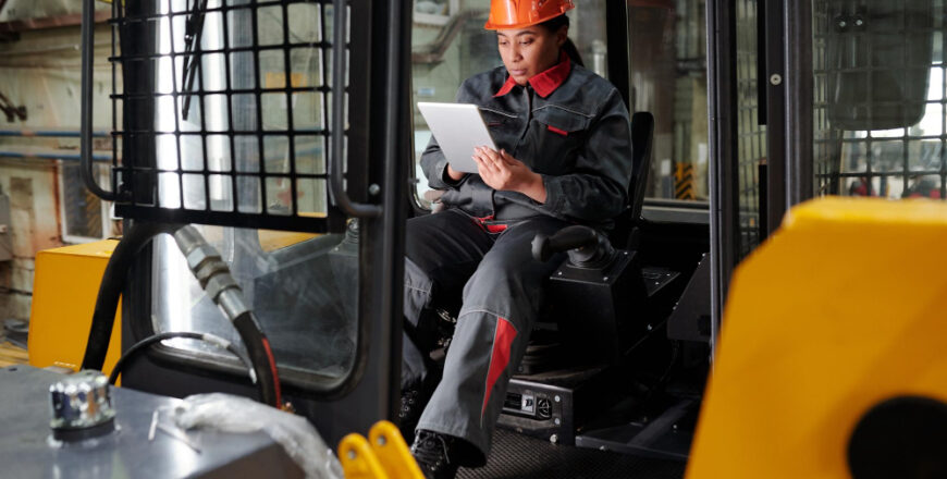 young-busy-worker-factory-scrolling-tablet-construction-machine