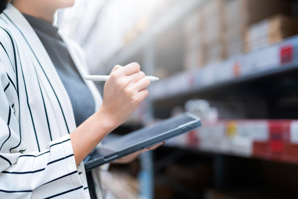 close-up-female-business-owner-hand-hold-tablet-device-checking-inventory-stock-at-shop-warehouse-distributor-factory-business-ideas-concept