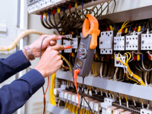 electrician-testing-electric-current-control-panel