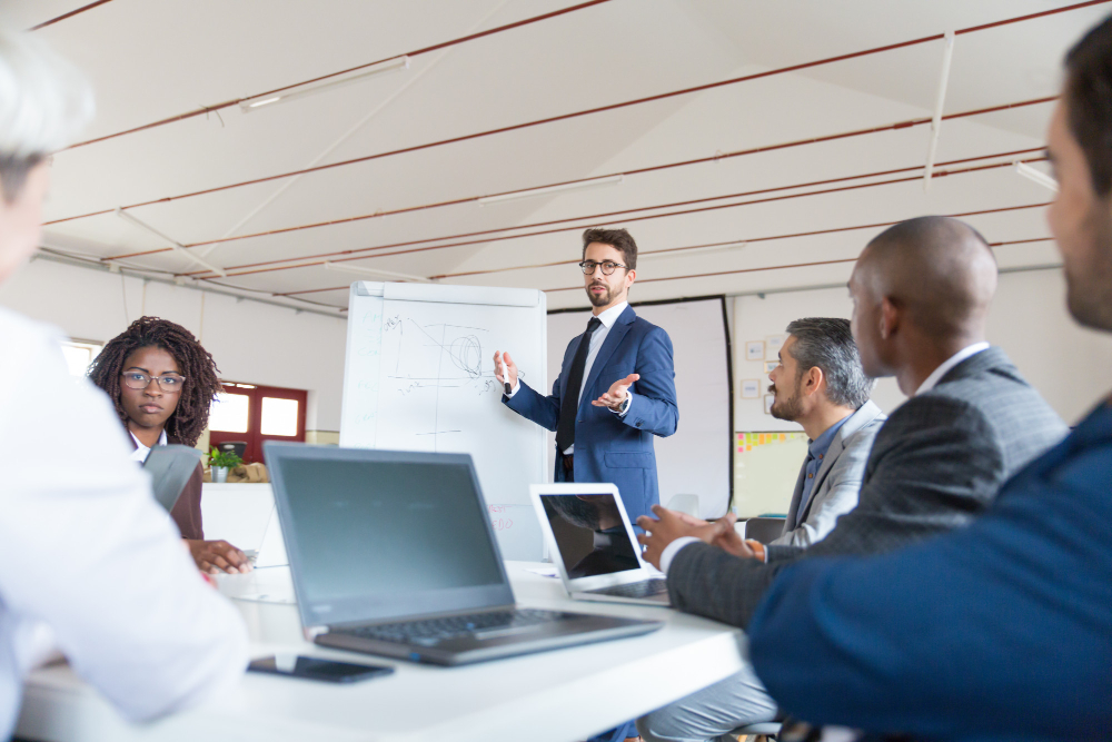 low-angle-shot-of-speaker-talking-and-looking-at-colleagues