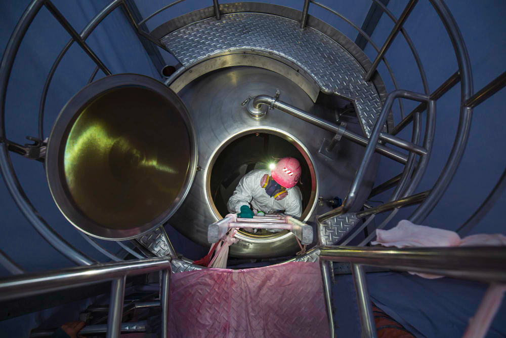 top-view-male-worker-climb-up-stairs-into-tank-stainless-chemical-area-confined-space