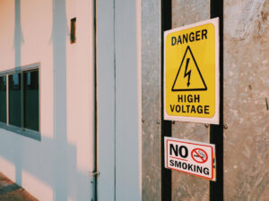 warning-danger-high-voltage-sign-no-smoking-label-steel-pipe-cover-outside-building
