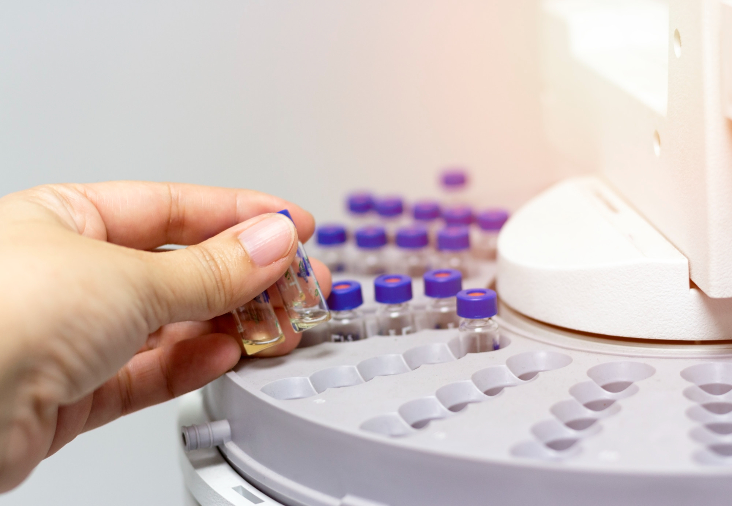 scientist-holds-chemical-sample-vial-people